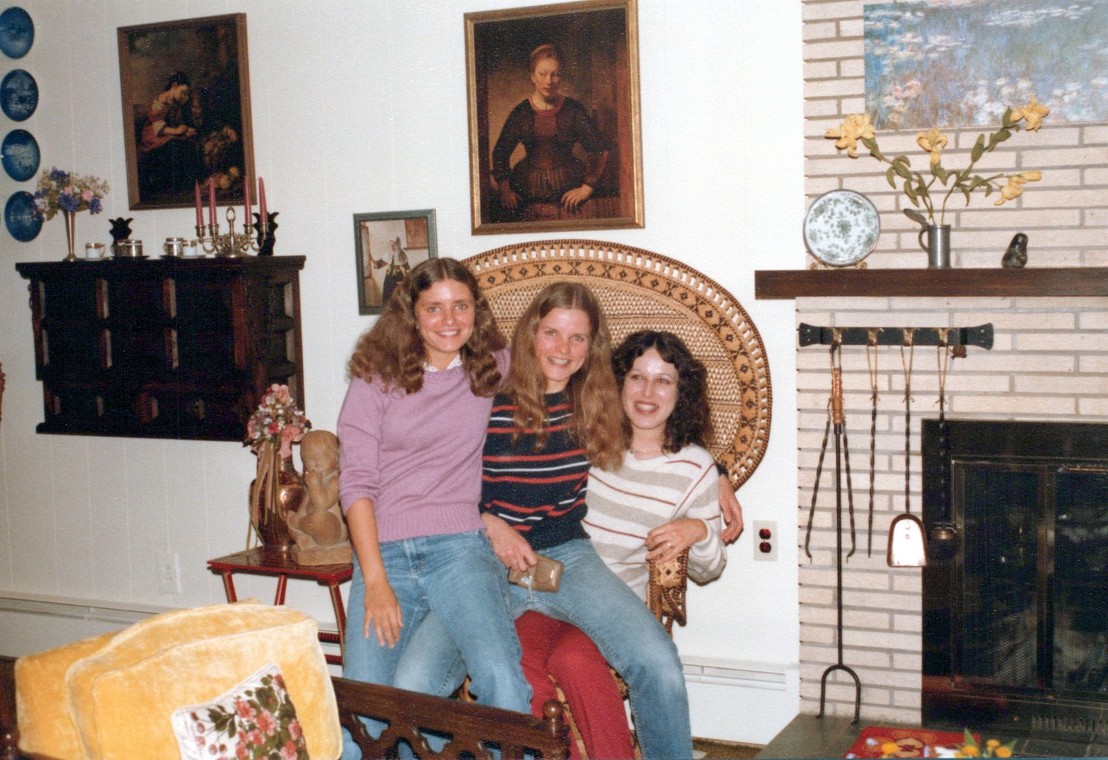 Three women sitting in a large chair